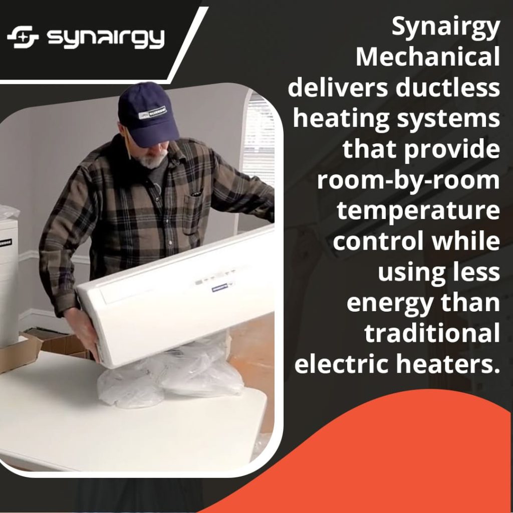A technician in a plaid shirt and cap unboxing a white ductless mini-split indoor unit.